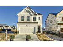 Charming two-story home with a white exterior, a two-car garage, and a well-manicured lawn at 197 S Finley Landing Parkway # 85, Smithfield, NC 27577