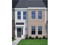 Charming two-story home with a combination of brick and siding, plus manicured landscaping at 207 Frosted Iris Lane St # 180, Garner, NC 27529