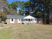 Charming brick home with well-manicured lawn, white trim and welcoming front porch at 3204 Jason Dr, Rocky Mount, NC 27803