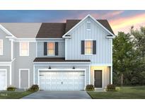 New construction home featuring light gray siding, a two car garage, and a covered front porch at 3410 Pelican Ln, Durham, NC 27703