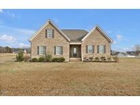Charming brick home with a well-maintained front lawn and classic architectural details at 4840 Baines Loop Rd, Spring Hope, NC 27882