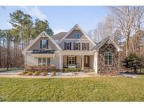 Charming home boasts a manicured lawn, stone accents, and a welcoming front porch at 659 Willard Dr, Creedmoor, NC 27522