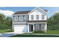 Two-story home featuring a two-car garage, neutral siding and decorative white trim at 69 Sunshine Rd, Kenly, NC 27542