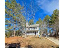 Charming two-story home featuring a front porch and a well-manicured yard on a sunny day at 701 Grandview Drive Dr, Durham, NC 27703