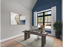 Bright home office with a large window, sleek desk, and stylish decor at 8621 Bishop Pine Ln, Wake Forest, NC 27587