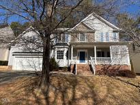 Charming two-story home features a covered porch and a two-car garage at 1015 Park Glen Pl, Durham, NC 27713