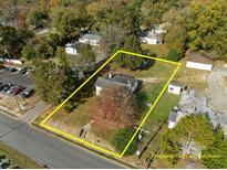 Aerial view of the property with yellow property line estimate surrounded by trees at 110 W Elm St, Nashville, NC 27856