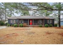 Charming single-story home featuring a welcoming front porch and a vibrant red front door at 1729 Augustus Dr, Rocky Mount, NC 27801
