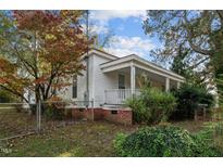 Charming single-Gathering home with a covered porch and mature trees in a lush, green yard at 219 N Richardson Ave, Nashville, NC 27856