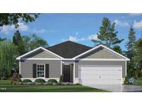 Charming single-story home featuring a two-car garage, neutral siding, and professionally landscaped front yard at 242 Palm Dr, Sanford, NC 27332