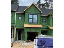 Unfinished townhome showcasing windows, garage, and Zip System sheathing, awaiting its final touches at 4073 Elk Creek Ln, Raleigh, NC 27612
