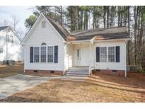 Charming single-story home with white siding, black shutters, and a well-maintained front yard at 4627 Sinclair Dr, Raleigh, NC 27616