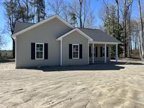 Charming single-story home featuring classic design elements and a welcoming front porch at 4722 Mcneill Hobbs Rd, Bunnlevel, NC 28323