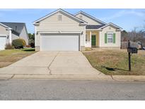 Charming home featuring a two-car garage, green shutters, and a well-manicured lawn at 4913 Sugargrove Ct, Apex, NC 27539