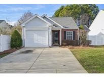 Charming single-story home with a brick accent, a garage, and a well-maintained front yard at 5548 Roan Mountain Pl, Raleigh, NC 27613