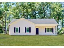 Charming single-story home featuring a classic design and well-maintained front yard, exuding curb appeal at 75 Pine Meadows Ln, Broadway, NC 27505