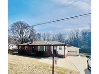 Charming brick home with a well-maintained lawn, detached garage and a classic suburban appeal at 764 Providence Rd, Roxboro, NC 27573