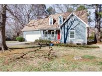 Charming two-story home with a well-manicured front yard and inviting front porch, two-car garage, and dormer windows at 103 Allison Way, Cary, NC 27511