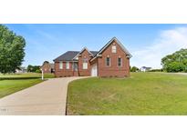 Charming all-brick home featuring an attached garage and a well-manicured front lawn at 105 Pinecrest Dr, Angier, NC 27501