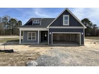 Charming home featuring an open garage, covered porch, and stylish architectural details at 147 Tuskeegee Dr, Smithfield, NC 27577