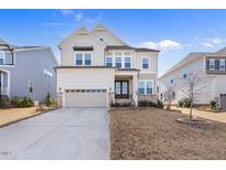 Charming two-story home featuring a stone-accented facade, a two-car garage, and well-maintained landscaping at 1516 Ferntree Ct, Morrisville, NC 27560