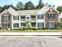 Attractive condo building with a mix of brick and siding, featuring green shutters and well-maintained landscaping at 1522 Kudrow Ln, Morrisville, NC 27560