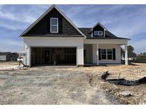 New home's exterior shows a two-story design with a black-and-white color scheme and an attached garage at 40 Tuskeegee Dr, Smithfield, NC 27577