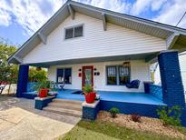 Charming two-story home with a blue-painted porch, swing, and manicured landscaping at 709 North St, Durham, NC 27701