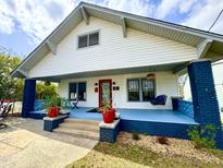 Charming home featuring a cozy front porch with a swing and vibrant blue flooring and trim at 709 North St, Durham, NC 27701