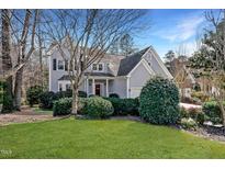 Charming two-story home with a manicured lawn and lush landscaping at 8712 Deerland Grove Dr, Raleigh, NC 27615