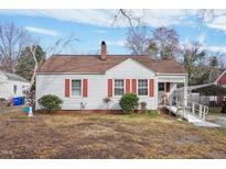 Charming single-story home featuring red shutters, a brown roof, and well-maintained vinyl siding at 115 Higbee St, Durham, NC 27704
