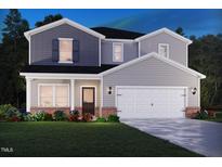 Charming two-story home with attached two-car garage, landscaped yard, and classic architectural details at 1750 Pie Filling Dr, Haw River, NC 27258