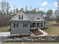Charming two-story home featuring manicured landscaping and a welcoming front porch in a serene setting at 20 Crane Dr, Louisburg, NC 27549