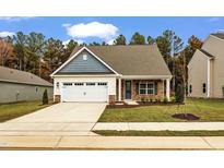 Charming single-Gathering home with a two-car garage, brick accents, and well-manicured lawn at 204 Jetson Creek Way, Youngsville, NC 27596