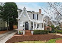 Charming two-story home with landscaped front yard, brick walkway, covered porch and inviting curb appeal at 2147 Wake Dr, Raleigh, NC 27608