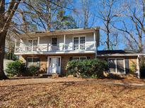 Charming two-story home featuring a brick facade, a white balcony and a well-maintained front yard at 310 E Pilot St, Durham, NC 27707
