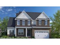 Beautiful two-story home featuring brick facade, white accents, and a two-car garage at 3184 Armeria Dr, Apex, NC 27502