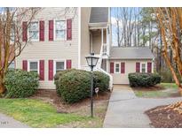 Charming townhome with red shutters, tidy landscaping, and a well-maintained exterior at 3307 Tarleton E # A-4, Durham, NC 27713