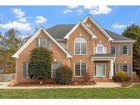 Charming two-story brick home features classic architectural details and a well-manicured front yard at 3816 Covina Dr, Raleigh, NC 27613