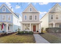 Charming two-story home with a welcoming front porch, landscaped yard, and gray siding at 4511 All Points View Way, Raleigh, NC 27614