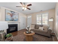 Inviting living room with a fireplace, hardwood floors, and neutral tones at 4511 All Points View Way, Raleigh, NC 27614