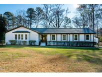 Charming single Gathering home featuring a well-maintained lawn and tidy landscaping at 5920 Holly Dr, Raleigh, NC 27616
