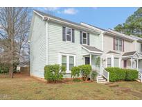 Charming two-story townhouse with light green siding and dark shutters at 621 Bashford Rd, Raleigh, NC 27606