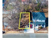 An aerial view of the property lot shows a defined parcel near a light blue two-story home at 822 Kent St, Durham, NC 27701