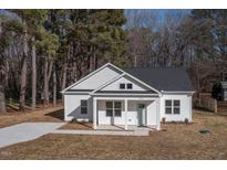 Charming single-story home with white siding, covered front porch, and newly installed driveway at 00 Cedar Grove Church Rd Rd, Roxboro, NC 27574
