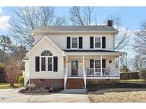 Charming two-story home featuring a welcoming front porch and classic architectural details at 100 Beech Forest Ct, Cary, NC 27513