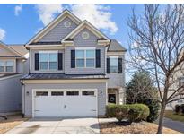 Charming two-story home with gray siding, black shutters, and a two-car garage at 109 Mainline Station Dr, Morrisville, NC 27560