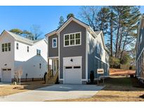 Charming two-story gray home with white trim, a one-car garage, and a concrete driveway at 1219 Chaney Rd, Raleigh, NC 27606