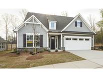 Charming home with a two-car garage, landscaped front yard, and inviting front door at 1758 Daiquiri Turn, Sanford, NC 27332
