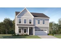 Charming two-story home with gray siding, stone accents, a two-car garage, and beautifully landscaped front yard at 187 E Fountainhead Ln, Garner, NC 27529